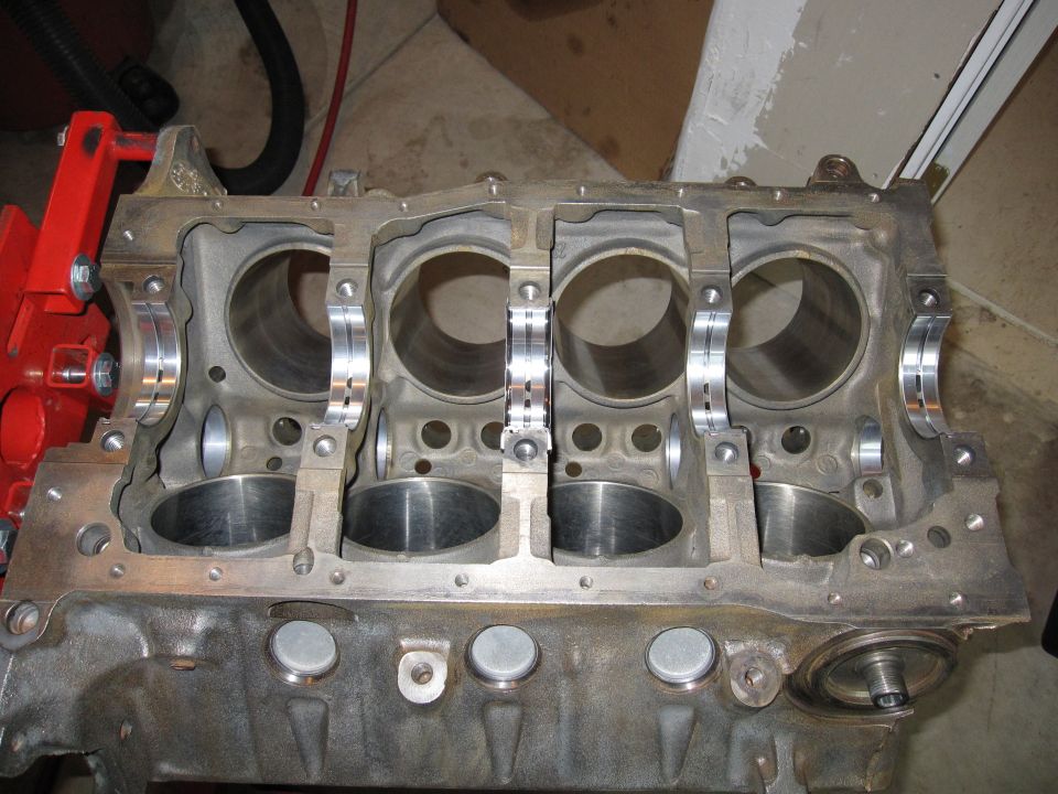Four-cylinder engine block with main bearing saddles visible