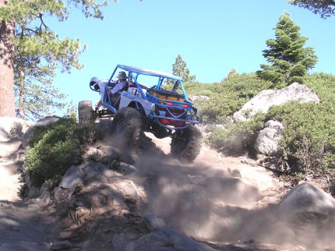 1994 Ford Bronco - This custom off-road buggy navigates a steep, rocky incline on a sunny day.