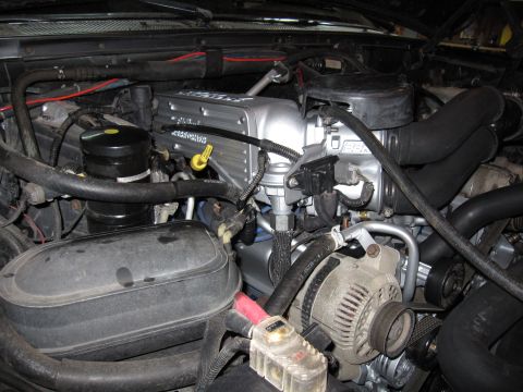 1996 Ford Bronco - Aftermarket valve covers installed on an engine, with visible 'BRONCO' lettering.