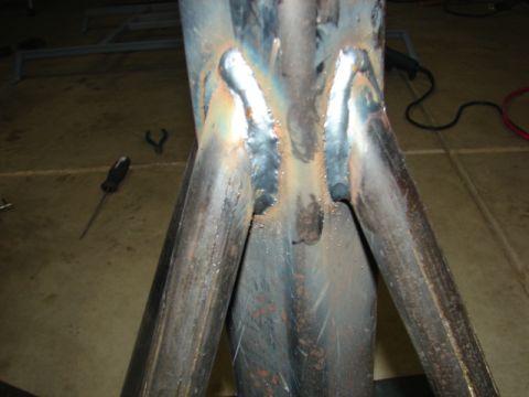 1996 Ford Bronco - Welded metal jack stand with a screwdriver and wrench on the floor nearby.