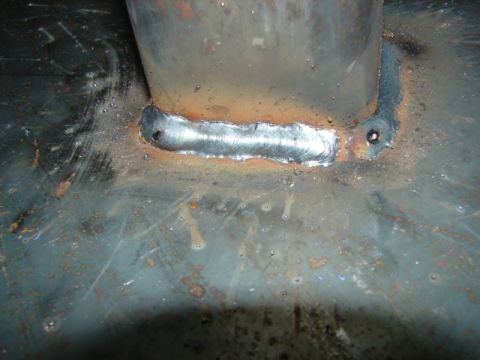 1996 Ford Bronco - Close-up of a welded metal bracket on a rusty surface, likely a repair or modification.