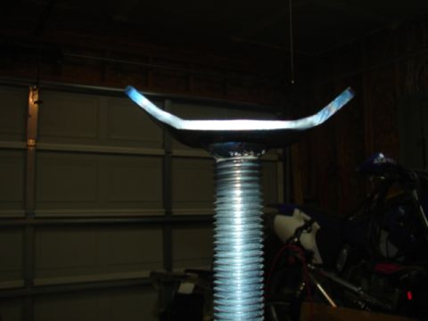 1996 Ford Bronco - A jack stand is shown in detail, with a threaded shaft and saddle.