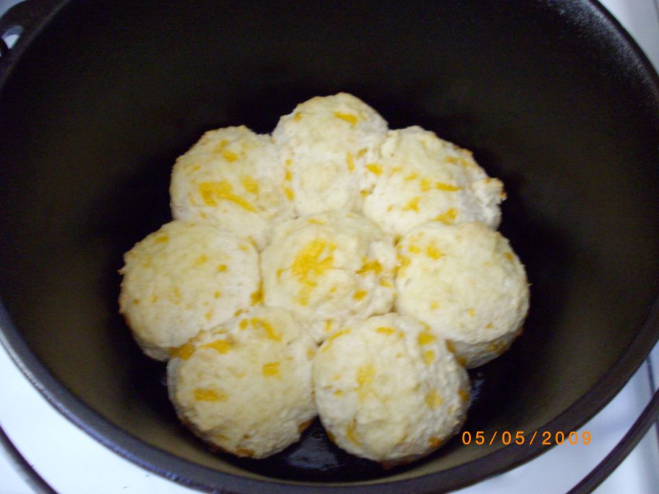 Cheese biscuits baking in a cast iron dutch oven