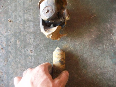1992 Ford F-350 - A driveshaft component appears to be broken and separated.