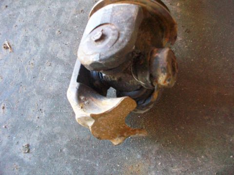1992 Ford F-350 - A close-up view of a damaged universal joint, showing a broken yoke.