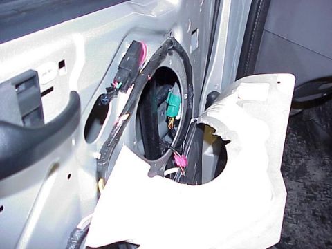 2007 Ford Mustang - Close-up of a car's interior door panel, showing exposed wiring and electrical connectors.