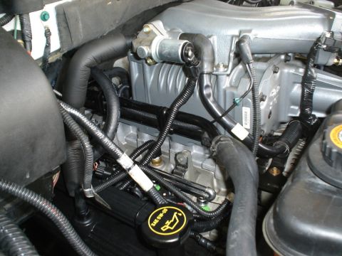 2007 Ford Mustang - Engine bay detail with supercharger and various hoses and wiring visible.