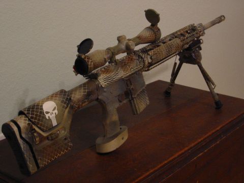 1996 Ford Bronco - A custom-painted rifle with a scope and bipod is displayed on a wooden surface.