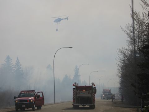 1996 Dodge 2500 - Emergency vehicles respond to a wildfire, with a helicopter assisting in water drops.