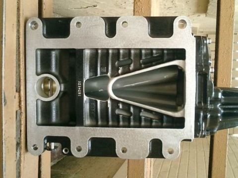 2007 Ford Mustang - A close-up view of a supercharger intake manifold, showing internal components and a visible part number.