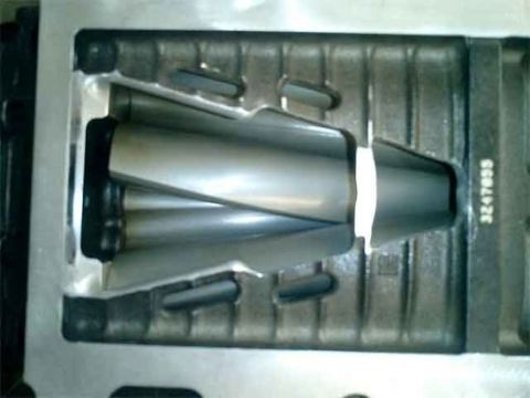 2007 Ford Mustang - A gray automotive part is held within a metal mold, with visible serial number 3247035.