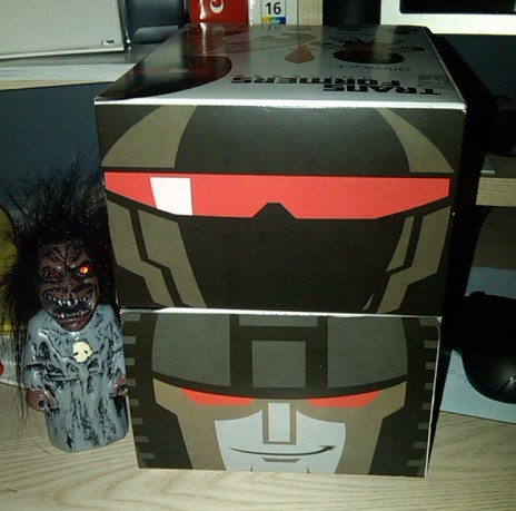 1991 Ford Bronco - Stacked Transformers toy boxes with character art and a small monster figure.