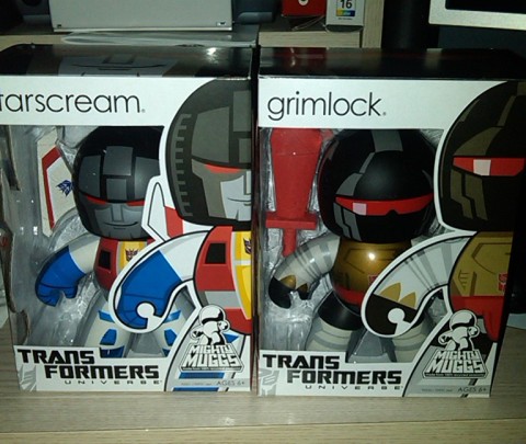 1991 Ford Bronco - Two collectible Transformers toys, Starscream and Grimlock, are displayed in their original packaging.
