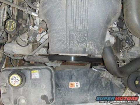 2003 Ford Crown Victoria - Close-up view of a vehicle's engine bay, showing the coolant reservoir and air intake components.