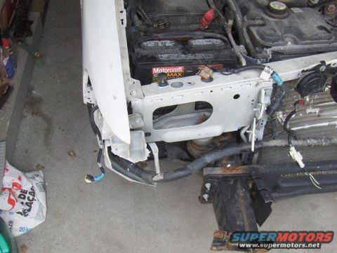 2003 Ford Crown Victoria - Front end damage on a 2003 Ford Crown Victoria, showing the battery and exposed components.