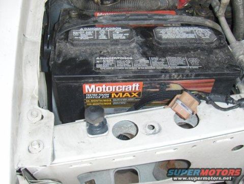 2003 Ford Crown Victoria - A close-up view of a Motorcraft car battery, highlighting its warning labels and service duration.