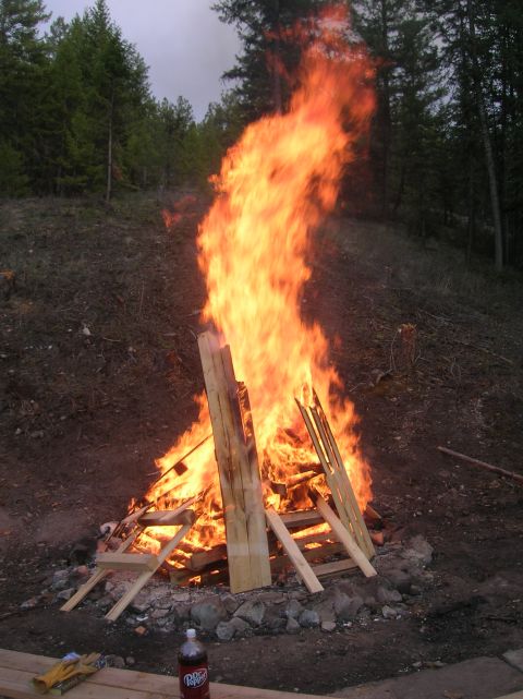 1996 Ford Bronco - A large bonfire burns brightly in a wooded area, with a bottle of Dr. Pepper visible on the ground nearby.