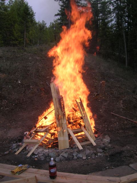 1996 Ford Bronco - A large bonfire burns intensely in a wooded area, with a Dr. Pepper bottle and gloves visible nearby.