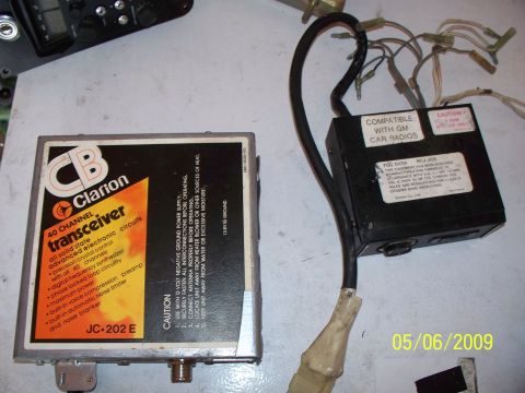 1982 Honda GL1100I GW Interstate - Two electronic modules, a Clarion CB transceiver and a GM car radio compatible module, are shown on a flat surface.