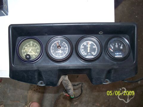 1982 Honda GL1100I GW Interstate - This motorcycle dashboard assembly features a clock, tachometer, temperature gauge, and voltmeter, all branded with "HONDA".
