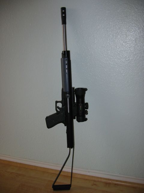 1996 Ford Bronco - A rifle with a scope and bipod is shown leaning against a wall.