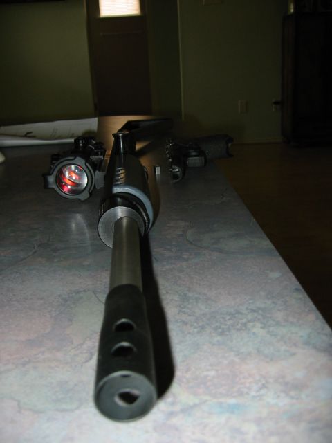 1996 Ford Bronco - Close-up of a gun barrel with a scope attached, and a pistol visible in the background.