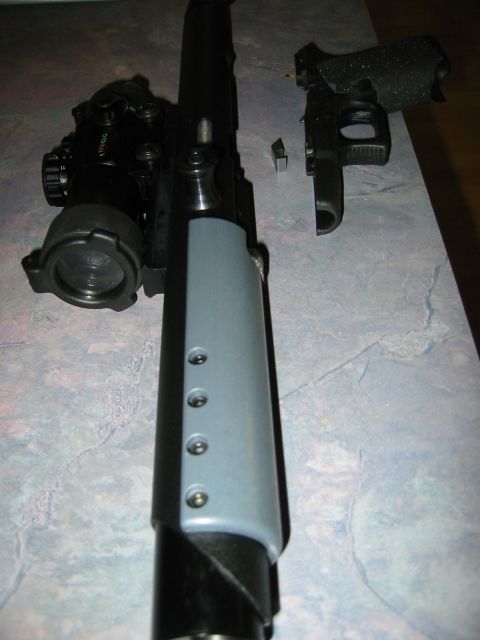1996 Ford Bronco - Disassembled firearm components are laid out on a textured surface.