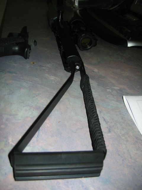 1996 Ford Bronco - A black metal and rubber part with a braided handle is shown on a table.