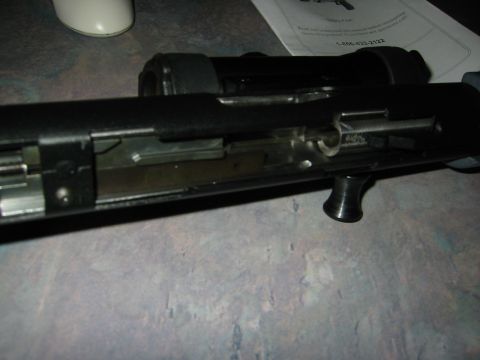 1996 Ford Bronco - Internal mechanism of a firearm shown in detail, with a document in the background.