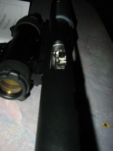 1996 Ford Bronco - A close-up view of a firearm's internal mechanism, with a scope mount visible on the side.