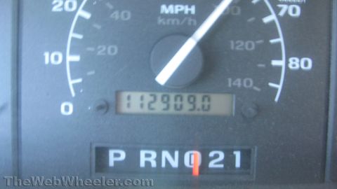 1996 Ford C-350 (Centurion Conversions) - Close-up of a Ford instrument cluster showing the MPH/km-h speedometer with the needle at rest and a mechanical odometer reading 112909.0 m…
