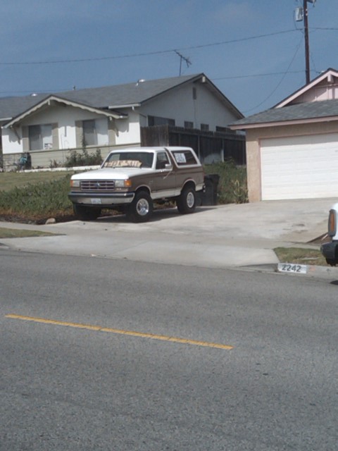 1982 Ford Bronco - This two-tone SUV is parked in a residential driveway, showing its 3/4 front view.