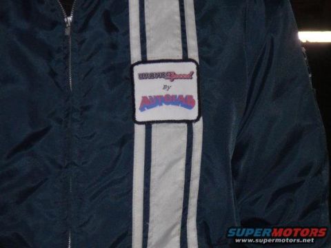 1984 Ford Bronco - Jacket with "BroncoSpeed By AUTO4X4" patch and racing stripes.