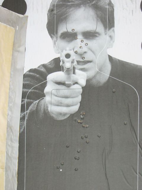 1996 Ford Bronco - Target practice image shows a man aiming a handgun, with numerous bullet impacts on the target.