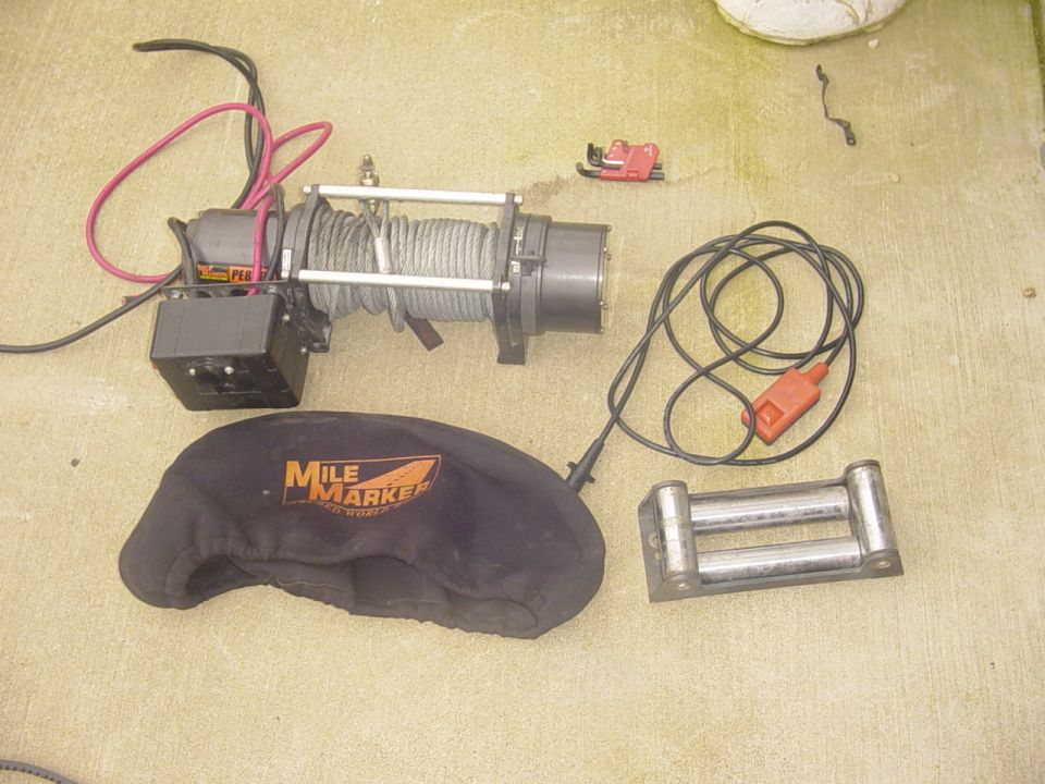 Winch with cover and roller fairlead
