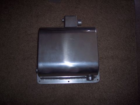 1971 Ford Mustang - Stainless steel muffler with visible welds and mounting plate, shown on a carpeted surface.