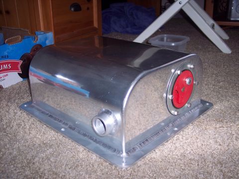 1971 Ford Mustang - Custom aluminum fuel tank with a red cap and threaded inlet, shown on a carpeted surface.