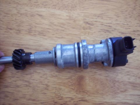 1971 Ford Mustang - A distributor part is shown against a wooden surface. The registry claims it is from a 1971 Ford Mustang, but this cannot be confirmed from…