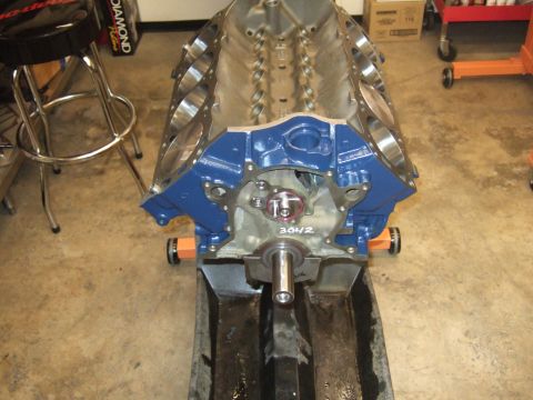 1971 Ford Mustang - Engine block with visible casting numbers sits on a stand in a garage setting.