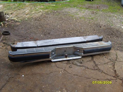 1989 Ford Bronco - Rear bumper assembly with tow ball and black rubber step pad is shown outdoors.