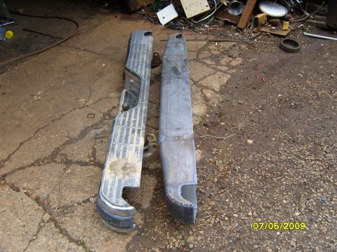 1989 Ford Bronco - A comparison of a chrome bumper and a bare metal bumper, possibly for a restoration project.