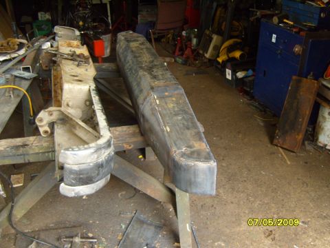 1989 Ford Bronco - A rear bumper assembly is shown mounted on a stand in a workshop setting.