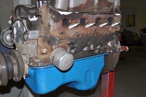 1996 Ford Bronco - Close-up view of a V8 engine block, its oil pan and spark plug attachments.