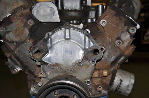 1996 Ford Bronco - Close-up of a corroded engine block, missing its water pump, with an oil filter attached.