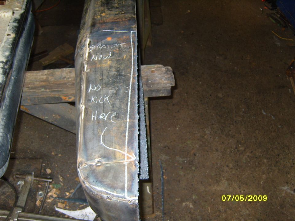 Metal bumper section with chalk markings 'STRAIGHT NOW' and 'NO KICK HERE'