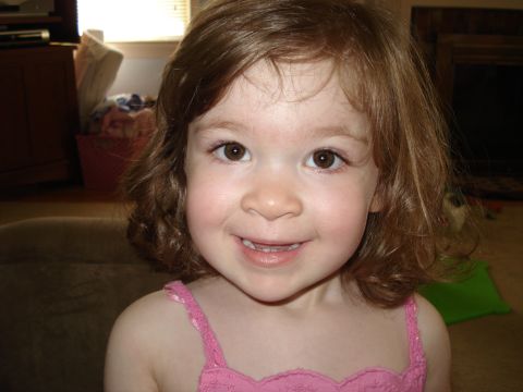 2000 Ford Crown Victoria - A close-up photo shows a young girl with curly brown hair and a bright smile.