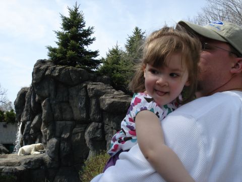 2000 Ford Crown Victoria - A child is held by an adult in front of a rocky enclosure with a polar bear visible.