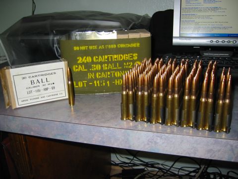 1996 Ford Bronco - A collection of .30 caliber ammunition and storage containers is displayed on a desk.