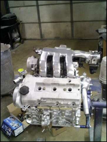 1994 Ford Probe - A clean engine assembly is shown in a workshop setting with a box of parts nearby.