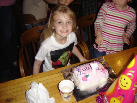 1993 Ford Bronco - A birthday celebration with a cake, a cup, and two young girls at a wooden table.